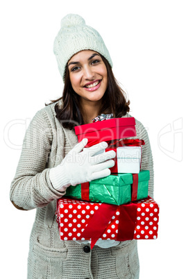 Festive brunette holding pile of gifts