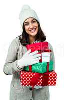 Festive brunette holding pile of gifts