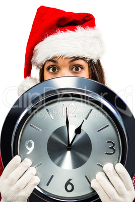 Festive brunette holding a clock