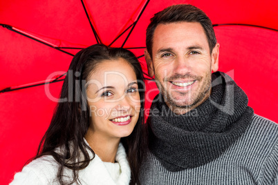 Smiling couple under umbrella