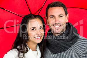 Smiling couple under umbrella