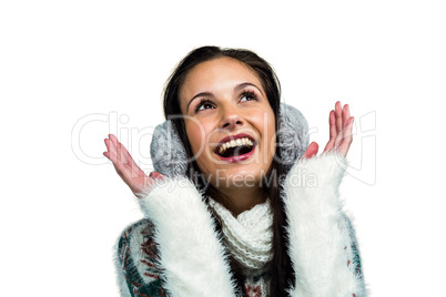Smiling woman with earmuffs looking up