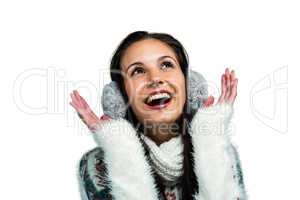 Smiling woman with earmuffs looking up