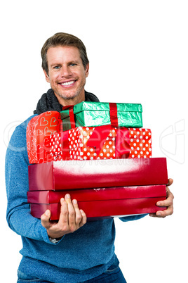 Festive man smiling and holding gifts