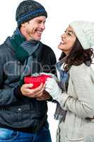 Festive couple exchanging a gift