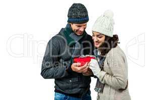 Festive couple exchanging a gift