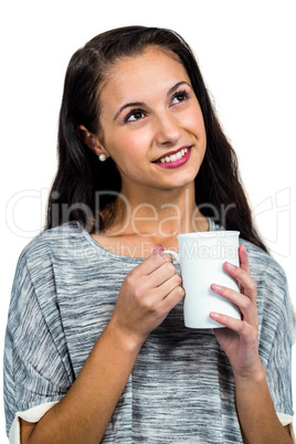 Day dreaming woman holding white cup