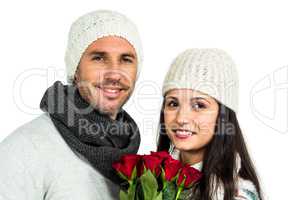 Smiling couple holding roses bouquet