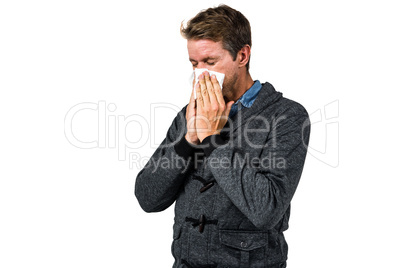 Warmly dressed man blowing his nose