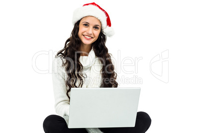 Smiling woman witted on floor using laptop