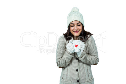 Festive brunette holding hot drink