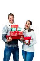 Festive couple smiling and holding gifts