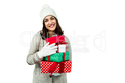 Festive brunette holding pile of gifts