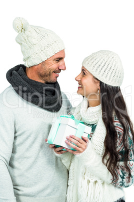 Smiling couple holding gift box