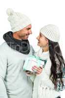 Smiling couple holding gift box
