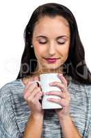 Smiling woman holding white cup