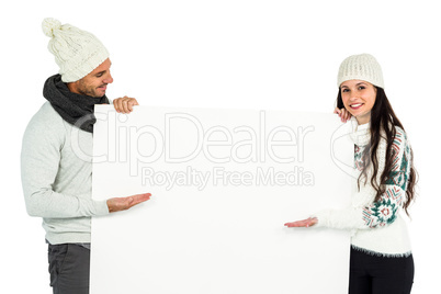 Smiling couple showing white sheet