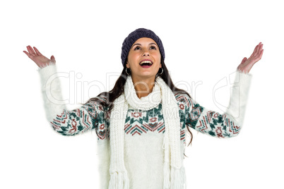 Smiling woman looking up with arms raised