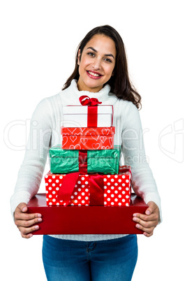 Festive brunette smiling with gifts