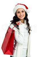 Attractive woman with christmas hat holding red shopping bag