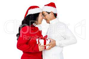 Festive senior couple exchanging gifts