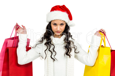 Woman with christmas hat holding colored shopping bags