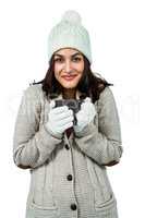 Festive brunette holding hot drink