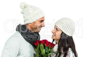 Smiling couple holding roses bouquet