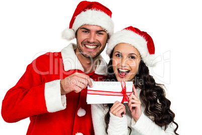 Festive couple exchanging a gift