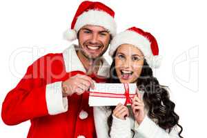 Festive couple exchanging a gift