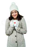 Festive brunette holding hot drink