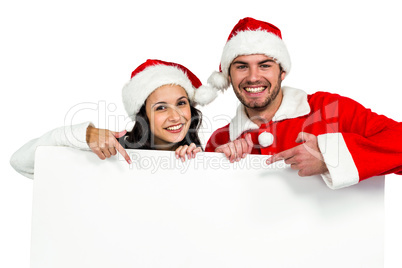 Festive couple showing a poster