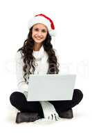 Smiling woman sitting on floor using laptop