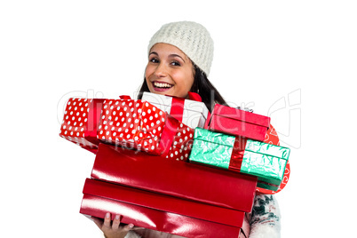 Smiling woman holding red and white gift boxes