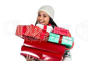 Smiling woman holding red and white gift boxes