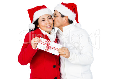 Festive senior couple exchanging gifts