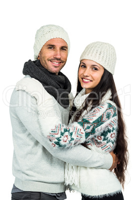 Smiling couple hugging and looking at camera