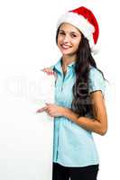 Festive brunette showing a sign