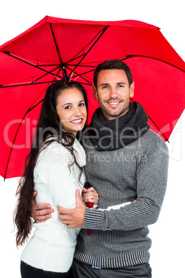 Smiling couple under umbrella