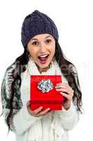 Surprised woman opening red gift box
