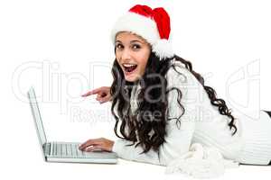Smiling woman using laptop laying on floor