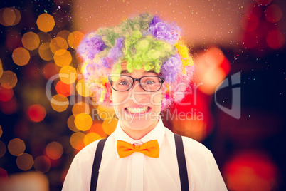 Composite image of geeky hipster wearing a rainbow wig