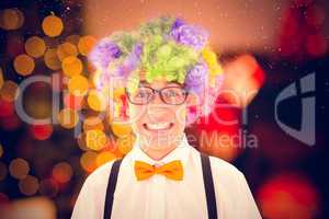 Composite image of geeky hipster wearing a rainbow wig