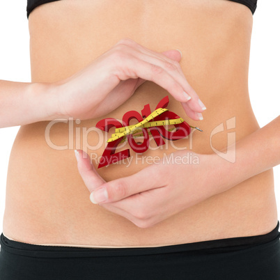 Composite image of closeup mid section of a fit woman with hand
