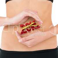 Composite image of closeup mid section of a fit woman with hand