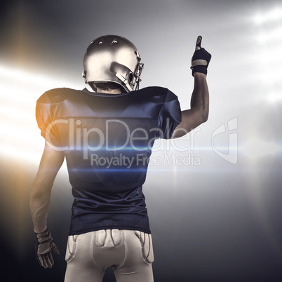 Composite image of rear view of american football player pointing