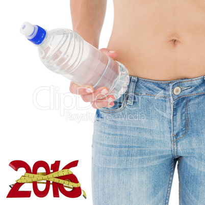 Composite image of fit woman standing with bottle of water