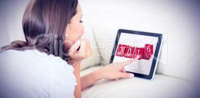 Composite image of woman touching her digital tablet