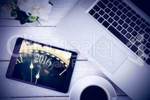 Composite image of tablet on desk