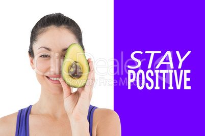 Composite image of pretty woman showing half of an avocado